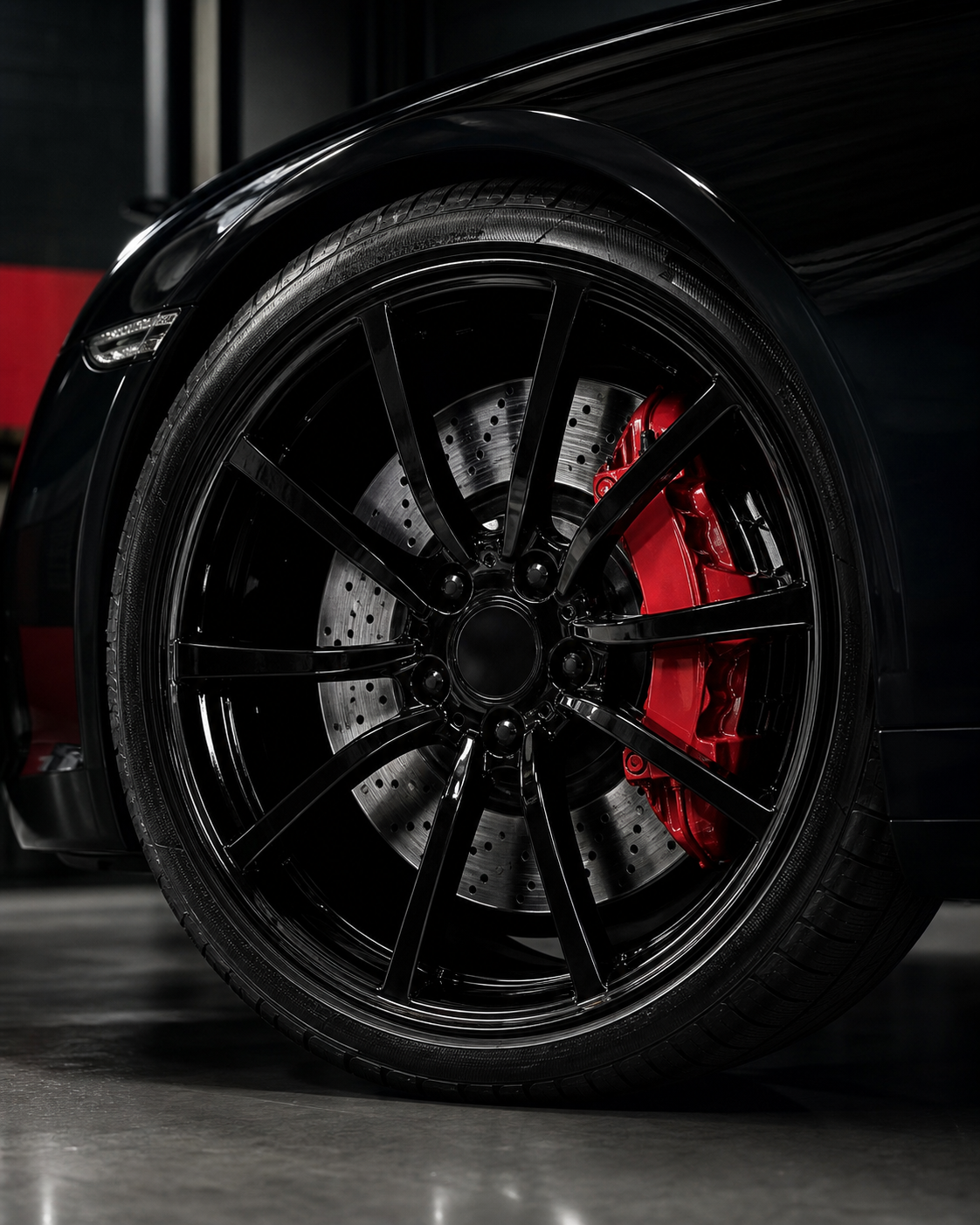 Gloss black custom wheel with a red brake caliper